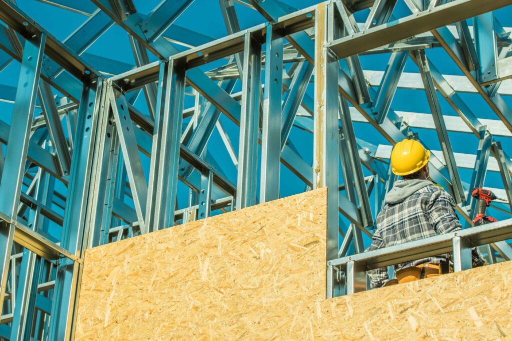 Steel Building Contractor reviewing work on construction site